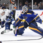 
              Vancouver Canucks right wing Conor Garland (8) is called for goaltender interference against St. Louis Blues goaltender Jordan Binnington (50) during the first period of an NHL hockey game Thursday, Feb. 23, 2023, in St. Louis. (AP Photo/Jeff Le)
            