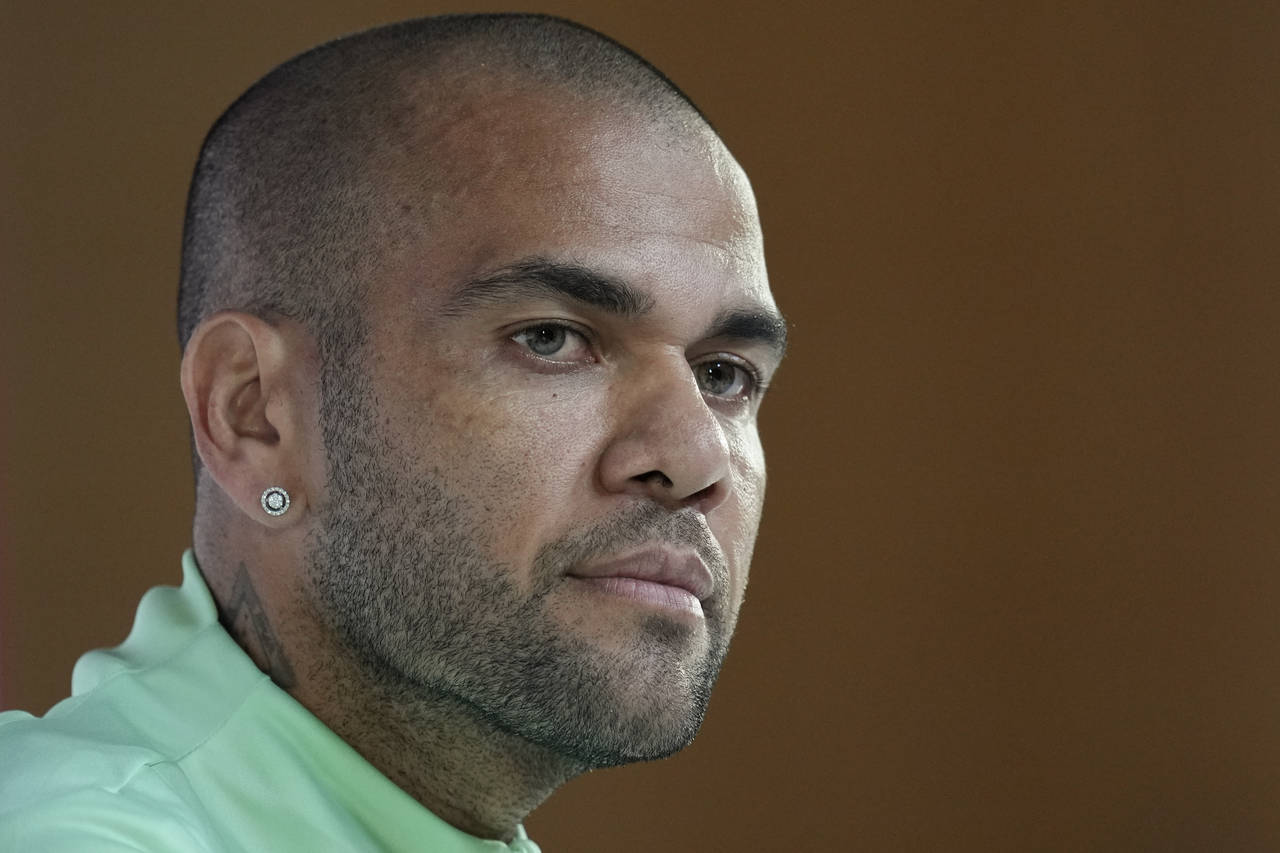 FILE - Brazil's Dani Alves listens to a question during a press conference on the eve of the group ...