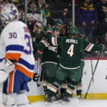 
              Minnesota Wild right wing Ryan Reaves, middle, celebrates with teammates after scoring a goal against New York Islanders goaltender Ilya Sorokin (30), left, during the first period of an NHL hockey game Tuesday, Feb. 28, 2023, in St. Paul, Minn. (AP Photo/Abbie Parr)
            