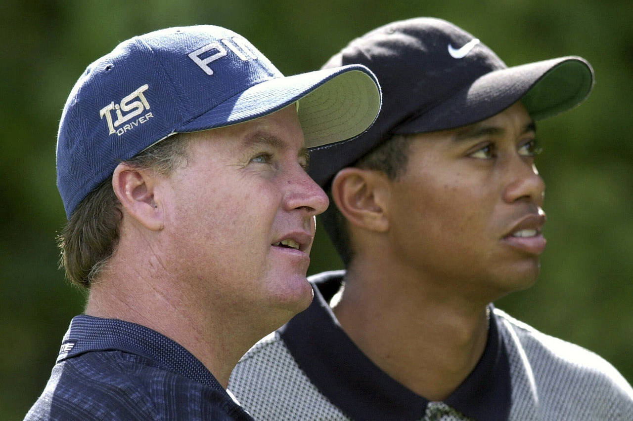 FILE - Bob May, of Las Vegas, Nev., left, along with with Tiger Woods, watches a tee shot fall on t...