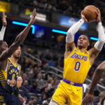 
              Los Angeles Lakers guard Russell Westbrook (0) shoots over Indiana Pacers guard Bennedict Mathurin (00) during the first half of an NBA basketball game in Indianapolis, Thursday, Feb. 2, 2023. (AP Photo/Michael Conroy)
            