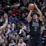 
              Brooklyn Nets' Cameron Johnson (2) shoots as Chicago Bulls' Coby White defends during the first half of an NBA basketball game Friday, Feb. 24, 2023, in Chicago. (AP Photo/Charles Rex Arbogast)
            