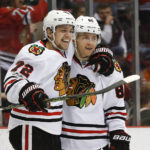 
              FILE - Chicago Blackhawks' Artemi Panarin (72) celebrates his goal against the Detroit Red Wings with Patrick Kane (88) in the first period of an NHL hockey game March 10, 2017, in Detroit. The New York Rangers have acquired Kane in a trade with the Blackhawks. The Rangers sent a conditional second-round pick and a future fourth-rounder to Chicago and a third-rounder in 2025 to Arizona to complete the deal. Kane joins the Rangers after waiving his no-movement clause to leave the only NHL organization he has known. (AP Photo/Paul Sancya, File)
            