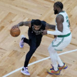 
              Brooklyn Nets guard Kyrie Irving, left, drives to the basket against Boston Celtics guard Jaylen Brown, right, during the first half of an NBA basketball game, Wednesday, Feb. 1, 2023, in Boston. (AP Photo/Charles Krupa)
            