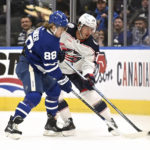 
              Toronto Maple Leafs right winger William Nylander (88) fights for the puck against Columbus Blue Jackets center Cole Sillinger (34) during the first period of an NHL hockey game Saturday, Feb. 11, 2023, in Toronto. (Jon Blacker/The Canadian Press via AP)
            