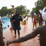 
              Prince Asante, the founder of Ghana's Awatu Winton Water Polo Club, shares tips with participants at the University of Ghana ahead of the Black Star water polo competition in Accra, Ghana, Saturday, Jan. 14, 2023. Former water polo pro Prince Asante is training young players in the sport in his father's homeland of Ghana, where swimming pools are rare and the ocean is seen as dangerous. (AP Photo/Misper Apawu)
            