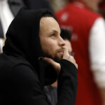 
              Golden State Warriors' Stephen Curry, watches Stanford from court-side during the first half of an NCAA college basketball game against UCLA on Monday, Feb. 20, 2023, in Stanford, Calif. (AP Photo/Josie Lepe)
            