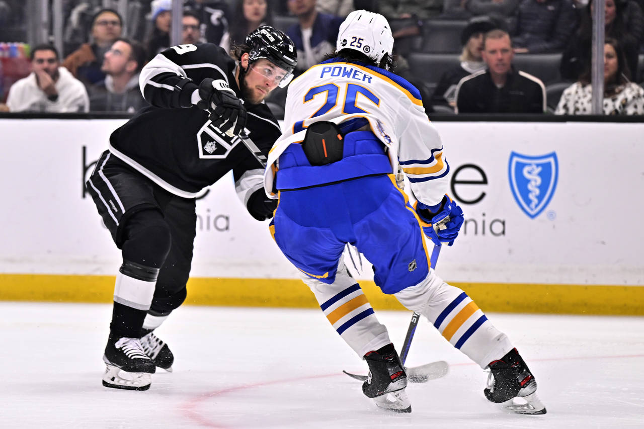 Los Angeles Kings right wing Adrian Kempe, left, shoots to score against Buffalo Sabres defenseman ...