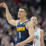 
              Denver Nuggets forward Michael Porter Jr. reacts after hitting a 3-point basket late in the second half of an NBA basketball game against the Los Angeles Clippers Sunday, Feb. 26, 2023, in Denver. (AP Photo/David Zalubowski)
            