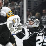 
              Los Angeles Kings goaltender Pheonix Copley, right, makes a glove save as Pittsburgh Penguins right wing Rickard Rakell watches during the second period of an NHL hockey game Saturday, Feb. 11, 2023, in Los Angeles. (AP Photo/Mark J. Terrill)
            