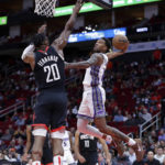 
              Sacramento Kings guard Malik Monk, right, goes up for a dunk as Houston Rockets forward Bruno Fernando (20) defends during the first half of an NBA basketball game Monday, Feb. 6, 2023, in Houston. (AP Photo/Michael Wyke)
            