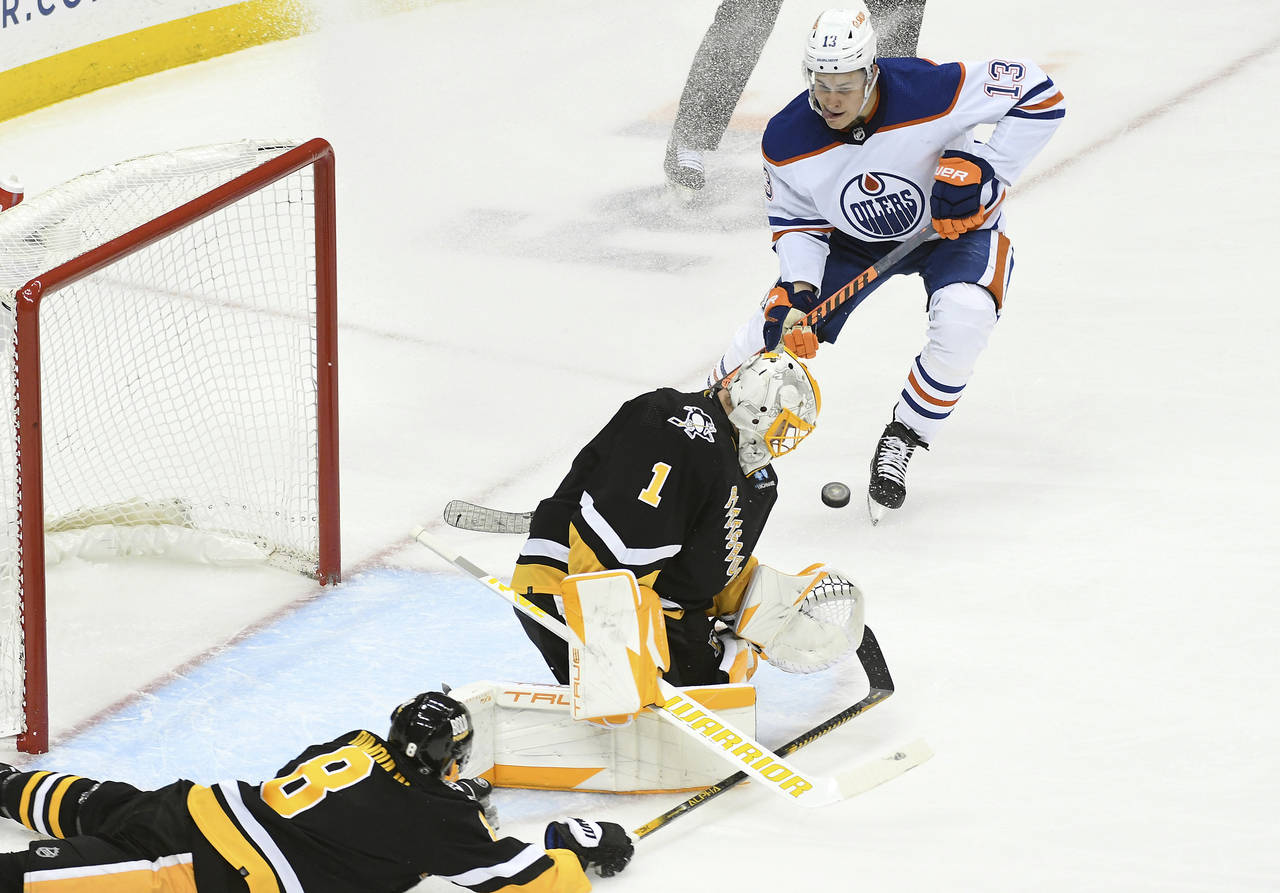 Pittsburgh Penguins goalie Casey DeSmith (1) makes a stop as Edmonton Oilers right wing Jesse Pulju...
