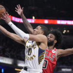 
              Indiana Pacers guard Tyrese Haliburton (0) shoots against Chicago Bulls guard Coby White during the first half of an NBA basketball game, Wednesday, Feb. 15, 2023, in Indianapolis. (AP Photo/Darron Cummings)
            