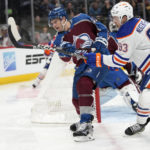 
              Colorado Avalanche defenseman Josh Manson, left, clears the puck as Edmonton Oilers center Ryan Nugent-Hopkins, right, defends in the second period of an NHL hockey game Sunday, Feb. 19, 2023, in Denver. (AP Photo/David Zalubowski)
            