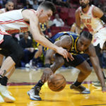 
              Miami Heat guard Tyler Herro, left, and Indiana Pacers guard Aaron Nesmith battle for a loose ball during the first half of an NBA basketball game, Wednesday, Feb. 8, 2023, in Miami. (AP Photo/Wilfredo Lee)
            