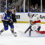 
              Florida Panthers goaltender Spencer Knight (30) deflects a shot on goal from St. Louis Blues' Noel Acciari (52) during the second period of an NHL hockey game, Tuesday, Feb. 14, 2023, in St. Louis. (AP Photo/Scott Kane)
            