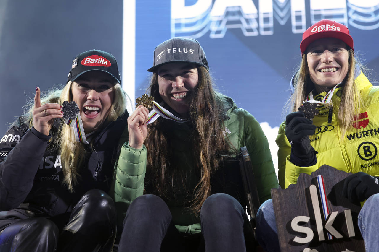 Canada's Laurence St-Germain, center, winner of the women's World Championship slalom, poses with s...