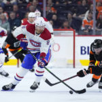 
              Montreal Canadiens' Mike Matheson (8) battle for the puck against Philadelphia Flyers' Olle Lycksell (62) during the third period of an NHL hockey game, Friday, Feb. 24, 2023, in Philadelphia. (AP Photo/Matt Slocum)
            