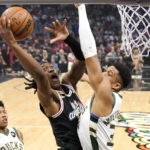 
              Los Angeles Clippers guard Terance Mann, left, shoots as Milwaukee Bucks forward Giannis Antetokounmpo defends during the first half of an NBA basketball game Friday, Feb. 10, 2023, in Los Angeles. (AP Photo/Mark J. Terrill)
            