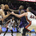 
              Charlotte Hornets guard Terry Rozier (3) attempts to drive between Miami Heat center Cody Zeller and Miami Heat forward Kevin Love (42) during the first half of an NBA basketball game, Saturday, Feb. 25, 2023, in Charlotte, N.C. (AP Photo/Matt Kelley)
            