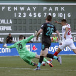 
              FILE — Liverpool goalie Andy Longergan (75) dives to make a save as Sevilla's Ocampos Lucas Ariel (25) tries to score past him and Liverpool's Andy Robertson (26) during the first half of a friendly soccer match at Fenway Park, July 21, 2019, in Boston. Fenway Park has kept busy in the offseason with hockey, football and other events that have turned one of baseball's crown jewels into a year-round venue. (AP Photo/Mary Schwalm, File)
            