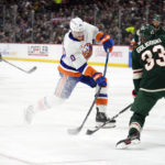 
              New York Islanders right wing Hudson Fasching, middle, shoots past Minnesota Wild defenseman Alex Goligoski (33) during the second period of an NHL hockey game Tuesday, Feb. 28, 2023, in St. Paul, Minn. (AP Photo/Abbie Parr)
            