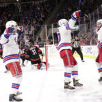 
              New York Rangers center Mika Zibanejad, right, celebrates his goal with left wing Chris Kreider, second from right, left wing Artemi Panarin, second from left, and center Filip Chytil, left, while Carolina Hurricanes goaltender Frederik Andersen (31) reacts during the first period of an NHL hockey game, Saturday, Feb. 11, 2023, in Raleigh, N.C. (AP Photo/Chris Seward)
            