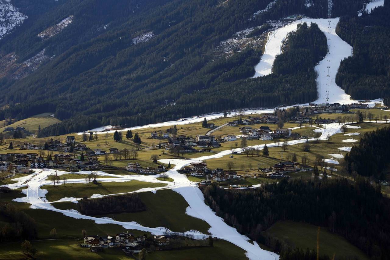 FILE - People ski on a strip of snow near Schladming, Austria, Friday, Jan. 6, 2023. Mother Nature ...