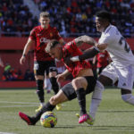 
              Real Madrid's Vinicius Junior, right, challenges for the ball with Mallorca's Pablo Maffeo during a Spanish La Liga soccer match between Mallorca and Real Madrid at the Son Moix stadium in Palma de Mallorca, Spain, Sunday, Feb. 5, 2023. (AP Photo/Francisco Ubilla)
            