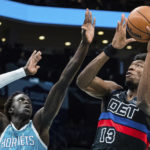 
              Detroit Pistons center James Wiseman (13) drives to the basket while guarded by Charlotte Hornets forward JT Thor (21) during the first half of an NBA basketball game in Charlotte, N.C., Monday, Feb. 27, 2023. (AP Photo/Jacob Kupferman)
            