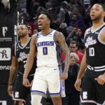 
              Sacramento Kings guard Malik Monk, center, celebrates as time runs out in double overtime while Los Angeles Clippers forward Norman Powell, left, and guard Eric Gordon look on during the second half of an NBA basketball game Friday, Feb. 24, 2023, in Los Angeles. The Kings won 176-175. (AP Photo/Mark J. Terrill)
            