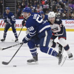 
              Toronto Maple Leafs left winger Michael Bunting (58) crosses into the offensive zone ahead of Columbus Blue Jackets right winger Mathieu Olivier (24) during second-period NHL hockey game action  Saturday, Feb. 11, 2023, in Toronto. (Jon Blacker/The Canadian Press via AP)
            