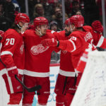 
              Detroit Red Wings players celebrate a goal by Pius Suter, second from left, during the third period of an NHL hockey game against the Washington Capitals, Tuesday, Feb. 21, 2023, in Washington. The Red Wigs won 3-1. (AP Photo/Julio Cortez)
            