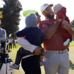 
              Jon Rahm celebrates with his family on the 18th green after winning the Genesis Invitational golf tournament at Riviera Country Club, Sunday, Feb. 19, 2023, in the Pacific Palisades area of Los Angeles. (AP Photo/Ryan Kang)
            