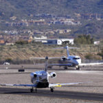 
              Private planes make their way to takeoff as Scottsdale Airport jet traffic is expected to increase dramatically leading up to the NFL Super Bowl LVII football game at Scottsdale Airport in Scottsdale, Ariz., Thursday, Feb. 2, 2023. (AP Photo/Ross D. Franklin)
            