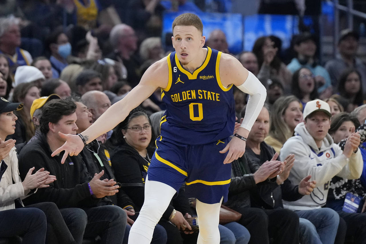 Golden State Warriors guard Donte DiVincenzo (0) gestures after making a 3-point basket during the ...