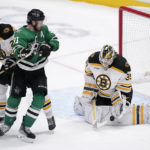 
              Boston Bruins goaltender Linus Ullmark (35) blocks a shot under pressure from Dallas Stars center Tyler Seguin (91) as Hampus Lindholm (27) helps defend on the play in overtime of an NHL hockey game, Tuesday, Feb. 14, 2023, in Dallas. (AP Photo/Tony Gutierrez)
            