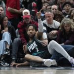 
              Portland Trail Blazers forward Trendon Watford (2) falls into the crowd during the first half of an NBA basketball game against the Chicago Bulls, Saturday, Feb. 4, 2023, in Chicago. (AP Photo/Erin Hooley)
            