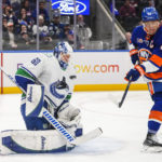 
              New York Islanders' Anders Lee (27) reacts to a puck shot by teammate Mathew Barzal past Vancouver Canucks goaltender Collin Delia (60) for a goal during the second period of an NHL hockey game Thursday, Feb. 9, 2023, in Elmont, N.Y. (AP Photo/Frank Franklin II)
            