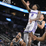 
              Sacramento Kings' Malik Monk (0) goes to the basket against San Antonio Spurs' Isaiah Roby, right, during the first half of an NBA basketball game, Wednesday, Feb. 1, 2023, in San Antonio. (AP Photo/Darren Abate)
            