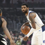 
              Dallas Mavericks guard Kyrie Irving, right, dribbles as Los Angeles Clippers guard Terance Mann defends during the first half of an NBA basketball game Wednesday, Feb. 8, 2023, in Los Angeles. (AP Photo/Mark J. Terrill)
            
