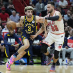 
              Indiana Pacers guard Chris Duarte (3) drives past Miami Heat guard Max Strus (31) during the first half of an NBA basketball game, Wednesday, Feb. 8, 2023, in Miami. (AP Photo/Wilfredo Lee)
            