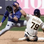 
              Los Angeles Dodgers' Gavin Lux tags out Milwaukee Brewers' Sal Frelick at second on a stolen base attempt during the second inning of a spring training baseball game Saturday, Feb. 25, 2023, in Phoenix. (AP Photo/Morry Gash)
            