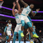 
              Charlotte Hornets center Mason Plumlee (24), guard Terry Rozier (3) and Detroit Pistons center Jalen Duren reach for the rebound during the first half of an NBA basketball game, Friday, Feb. 3, 2023, in Detroit. (AP Photo/Carlos Osorio)
            