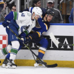 
              Vancouver Canucks center Elias Pettersson (40) checks St. Louis Blues left wing Pavel Buchnevich (89) during the second period of an NHL hockey game Thursday, Feb. 23, 2023, in St. Louis. (AP Photo/Jeff Le)
            