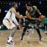 
              Boston Celtics' Jayson Tatum, right, looks to move against Phoenix Suns' Ish Wainright during the first half of an NBA basketball game, Friday, Feb. 3, 2023, in Boston. (AP Photo/Michael Dwyer)
            