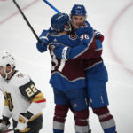 
              Colorado Avalanche right wing Mikko Rantanen, right, hugs left wing J.T. Compher after scoring as Vegas Golden Knights right wing Michael Amadio skates past in the first period of an NHL hockey game Monday, Feb. 27, 2023, in Denver. (AP Photo/David Zalubowski)
            