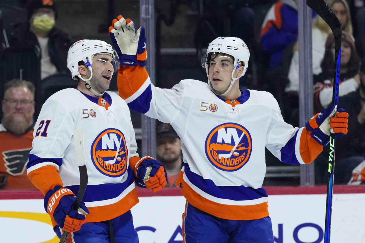 New York Islanders' Kyle Palmieri, left, and Jean-Gabriel Pageau celebrate after a goal by Palmieri...