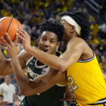
              Michigan State guard A.J. Hoggard (11) is defended by Michigan guard Kobe Bufkin during the first half of an NCAA college basketball game, Saturday, Feb. 18, 2023, in Ann Arbor, Mich. (AP Photo/Carlos Osorio)
            