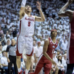 
              Alabama guard Jahvon Quinerly (5) works by Arkansas guard Ricky Council IV (1) for a shot during the second half of an NCAA college basketball game, Saturday, Feb. 25, 2023, in Tuscaloosa, Ala. (AP Photo/Vasha Hunt)
            